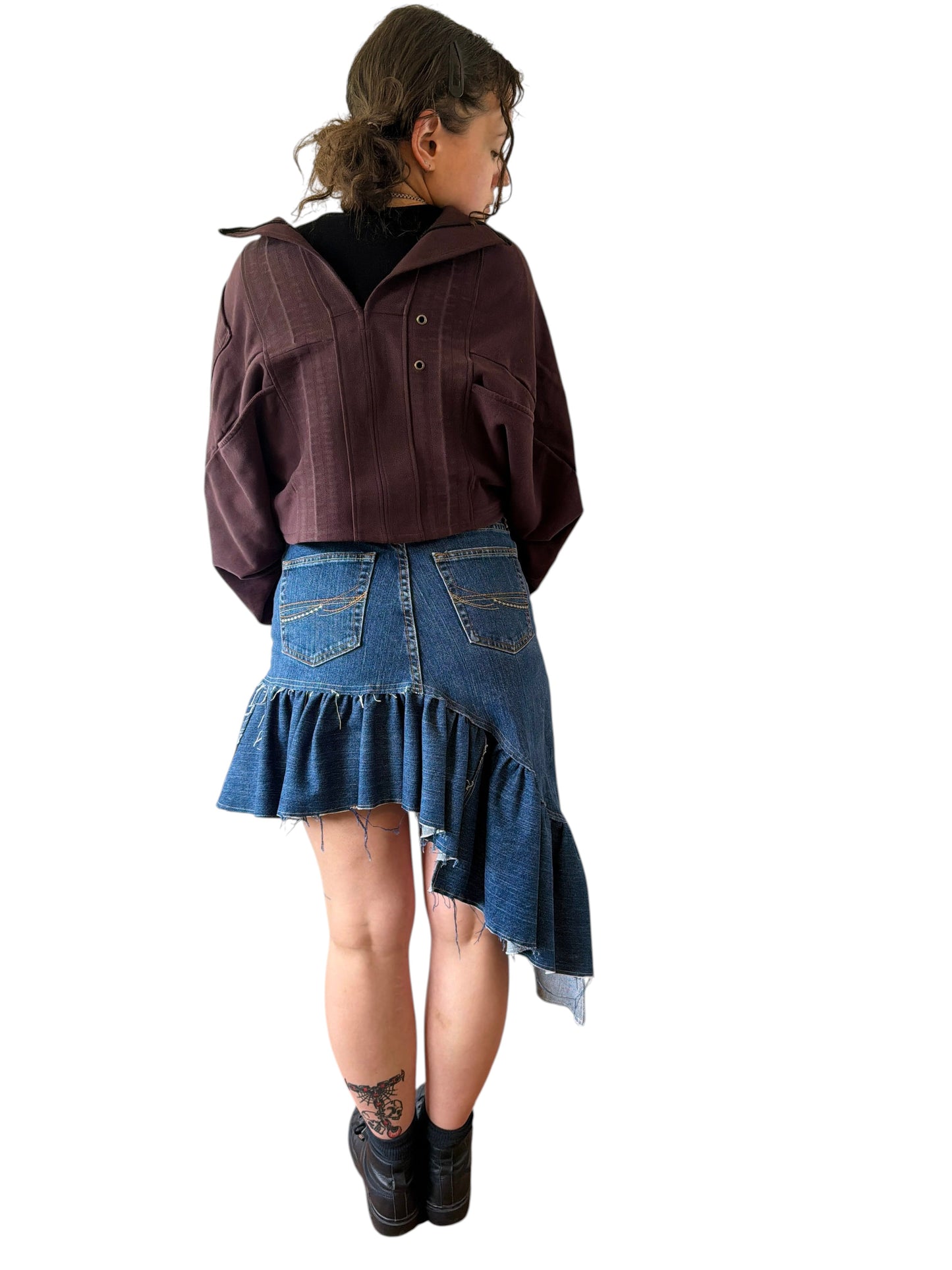 0 mph shrugly made from upcycled brown flannel and denim scraps, worn by a model against a white wall.