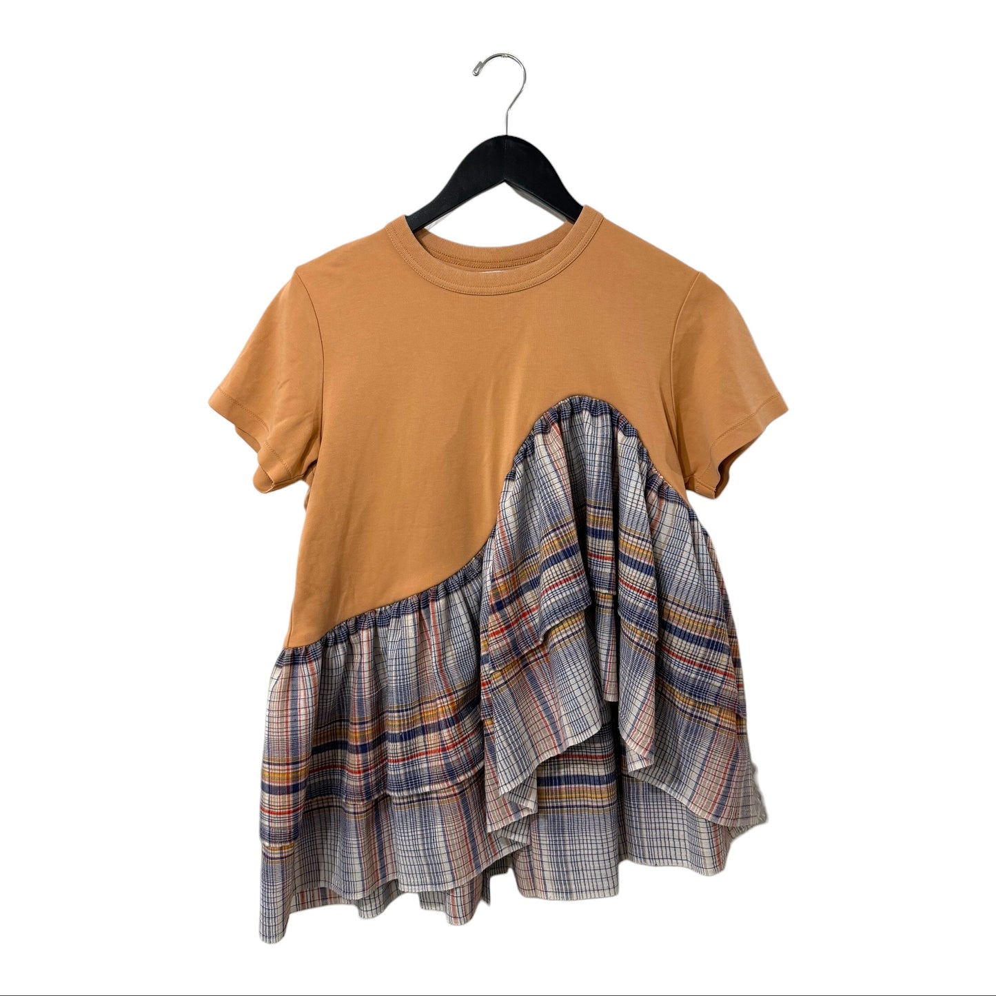 0 mph tan jersey t-shirt with an asymmetrical ruffled plaid hem and short sleeves hanging on a black hanger.