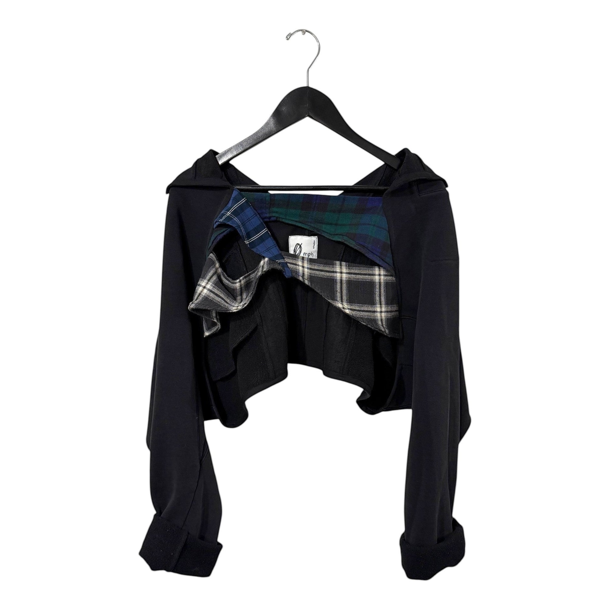 0 mph black cropped layered jacket with deconstructed plaid interior detailing on a hanger.