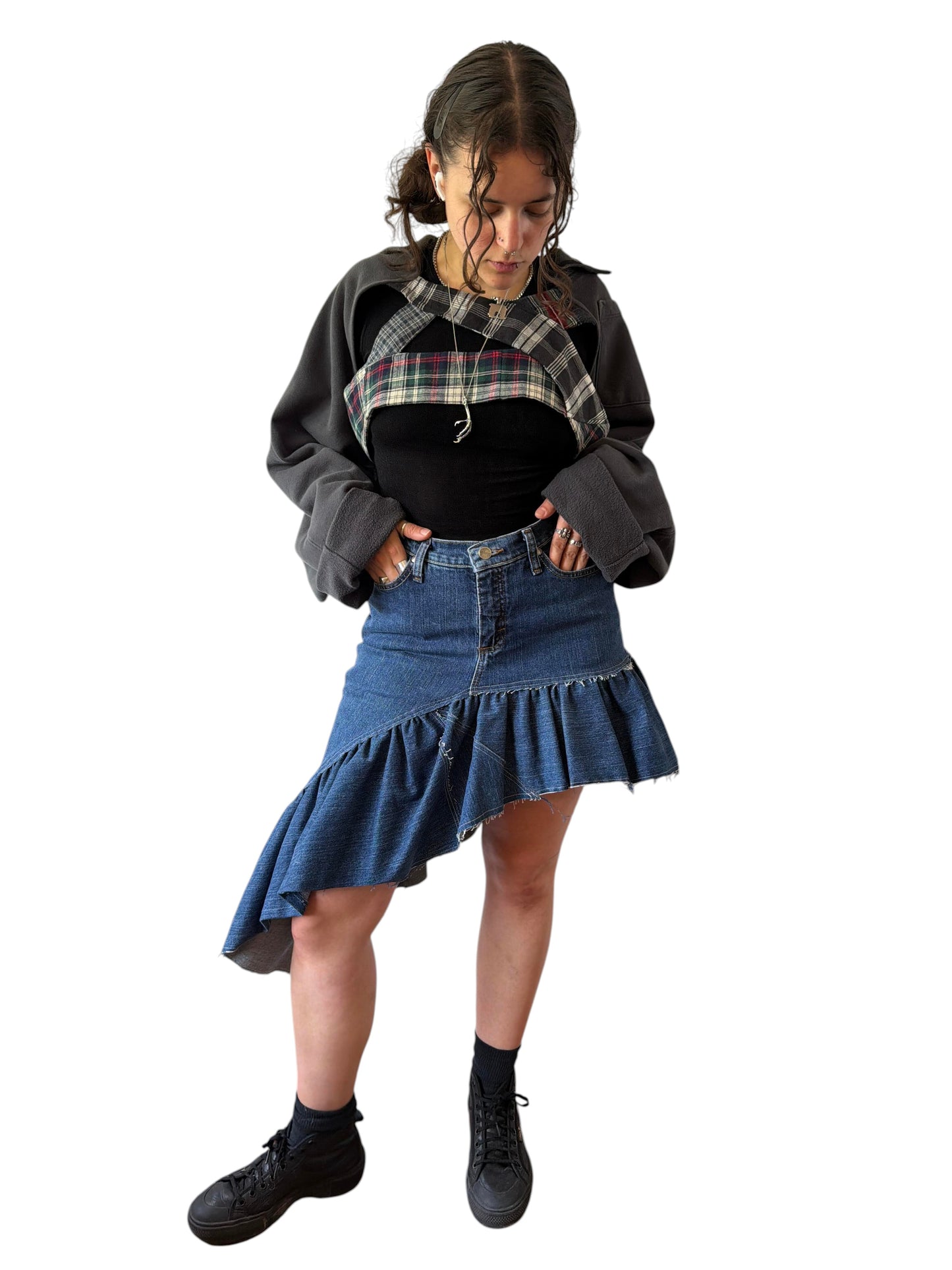 0 mph upcycled shrug made from flannel and pants scraps, worn by a model over a black top and denim skirt.