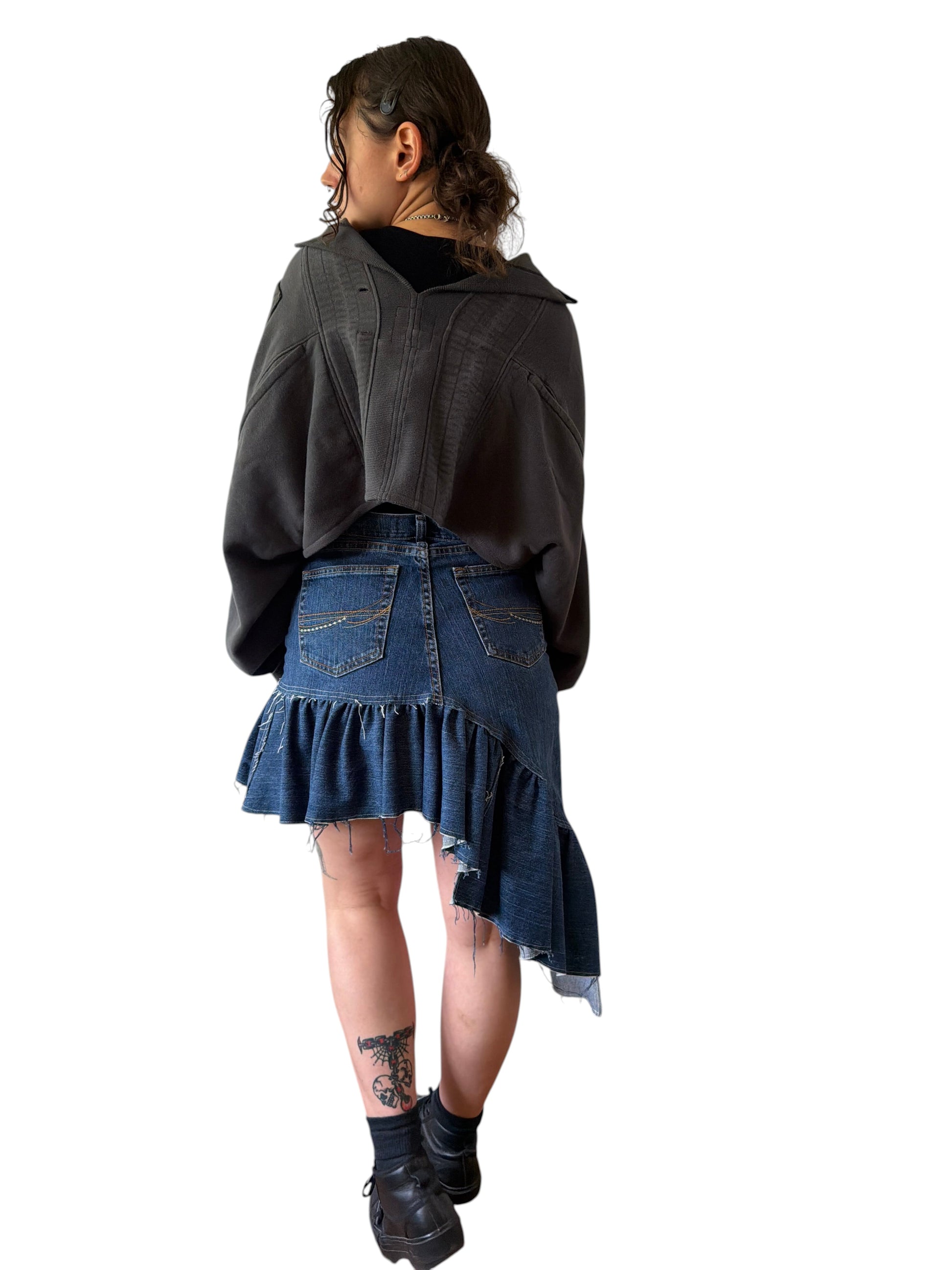 0 mph upcycled charcoal grey shrug made from flannel and pants scraps, worn by a model in a casual studio setting.