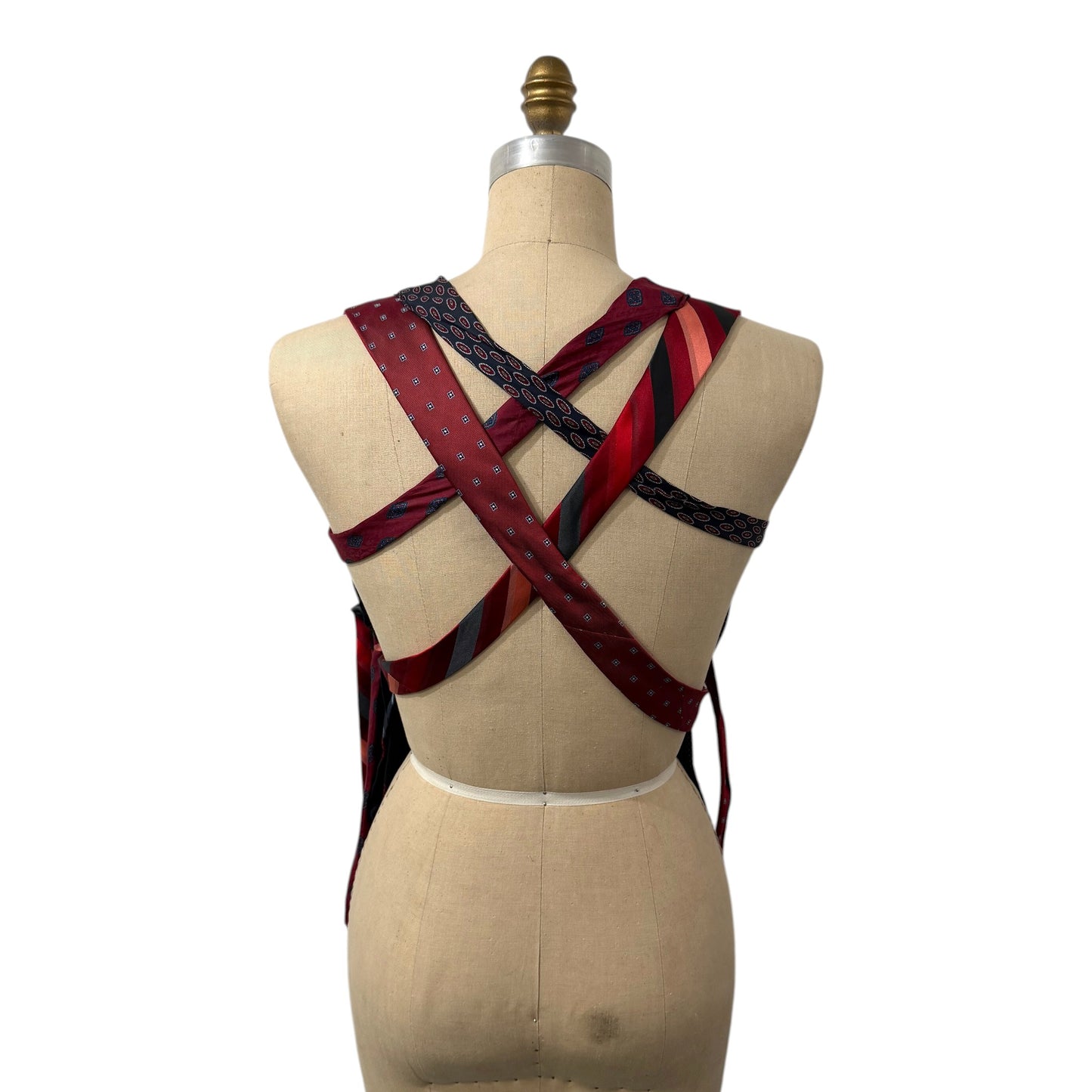 0 mph upcycled corset top featuring a crisscross back made from vintage red and navy patterned neckties on a mannequin