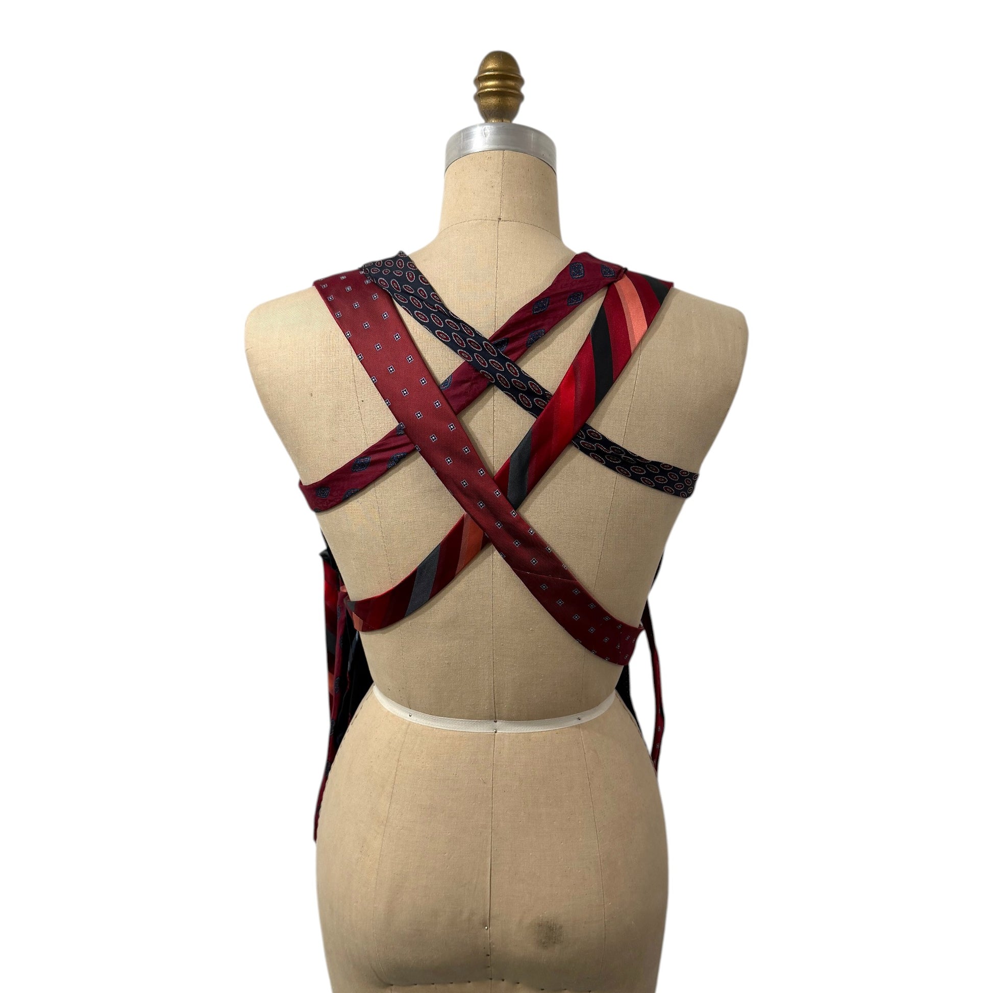 0 mph upcycled corset top featuring a crisscross back made from vintage red and navy patterned neckties on a mannequin