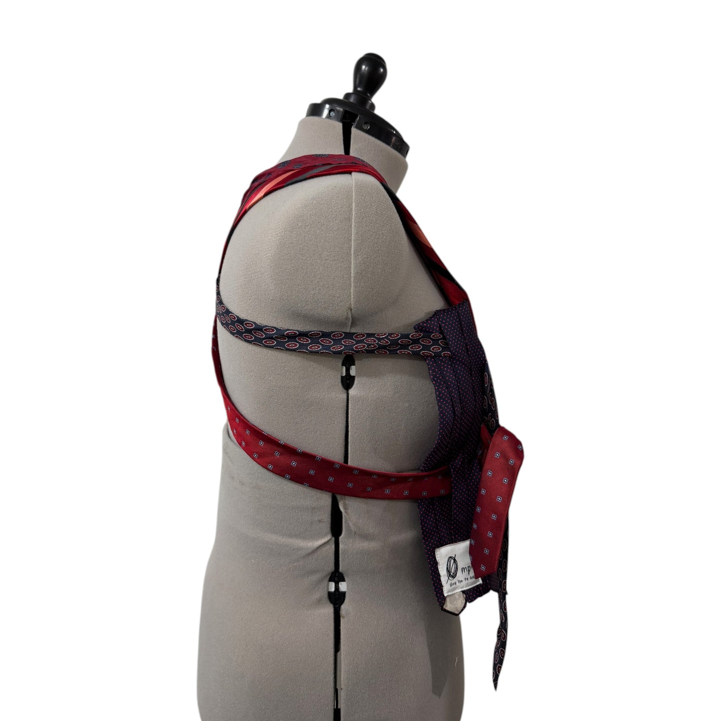 0 mph upcycled necktie corset top in red and navy blue patchwork silk on a dress form, side view.