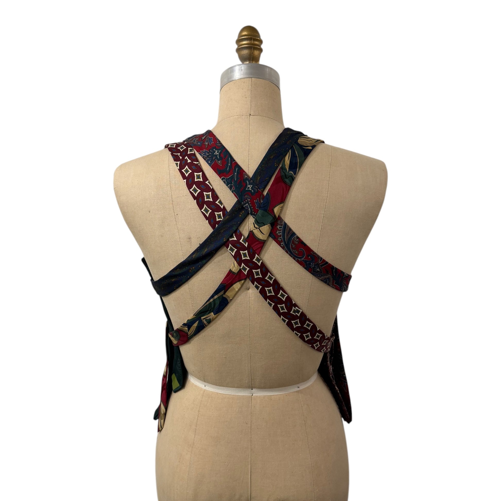 0 mph upcycled necktie vest with a crisscross back design, featuring vintage silk patterns in red, blue, and gold.