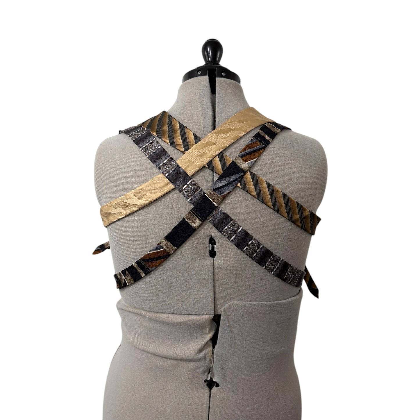 0 mph upcycled necktie patchwork vest in earthy brown, black, and gold silk, displayed on a mannequin back.