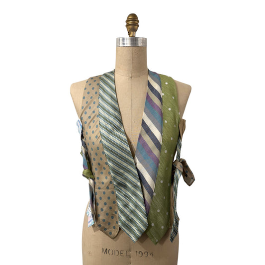 0 mph upcycled necktie vest in sage green, tan, and blue with polka dot and stripe patterns on a dress form.